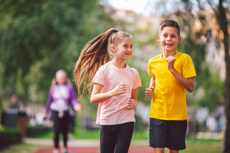 Picture of a young girl and boy jogging next to each other.