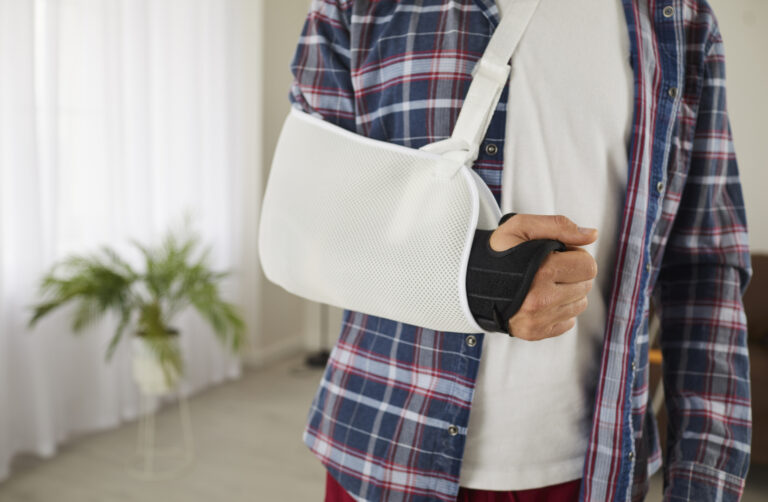 Picture of a man with his injured arm in a sling.