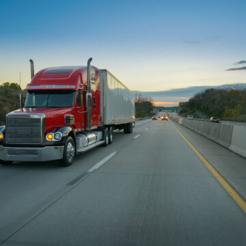 Picture of a commercial truck driving on a highway.